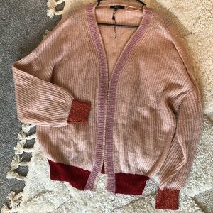 Soft pink sweater with colored sparkle detail